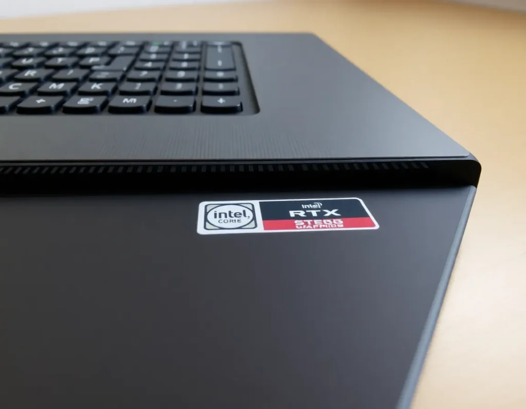 Close up shot of the Lenovo Legion Pro keyboard and cooling vents, clear view of the Intel Core i9 and RTX graphics stickers, metal surface texture visible, neutral lighting, tech review photography style, soft shadows, crisp details.